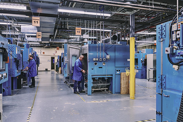 Manufacturing floor in a factory with blue machinery