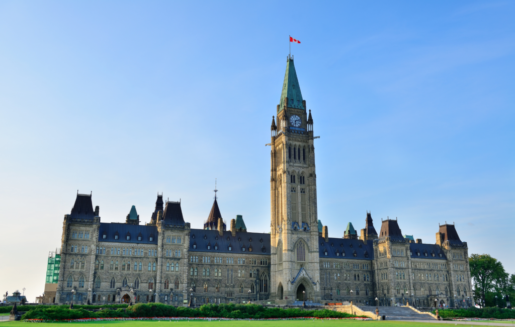 An image of the Ottawa skyline at dusk, overlooking the Pariliament buildings and the National Arts Centre