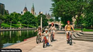 A family enjoying a cycle ride together along the Rideau Canal in Ottawa. 